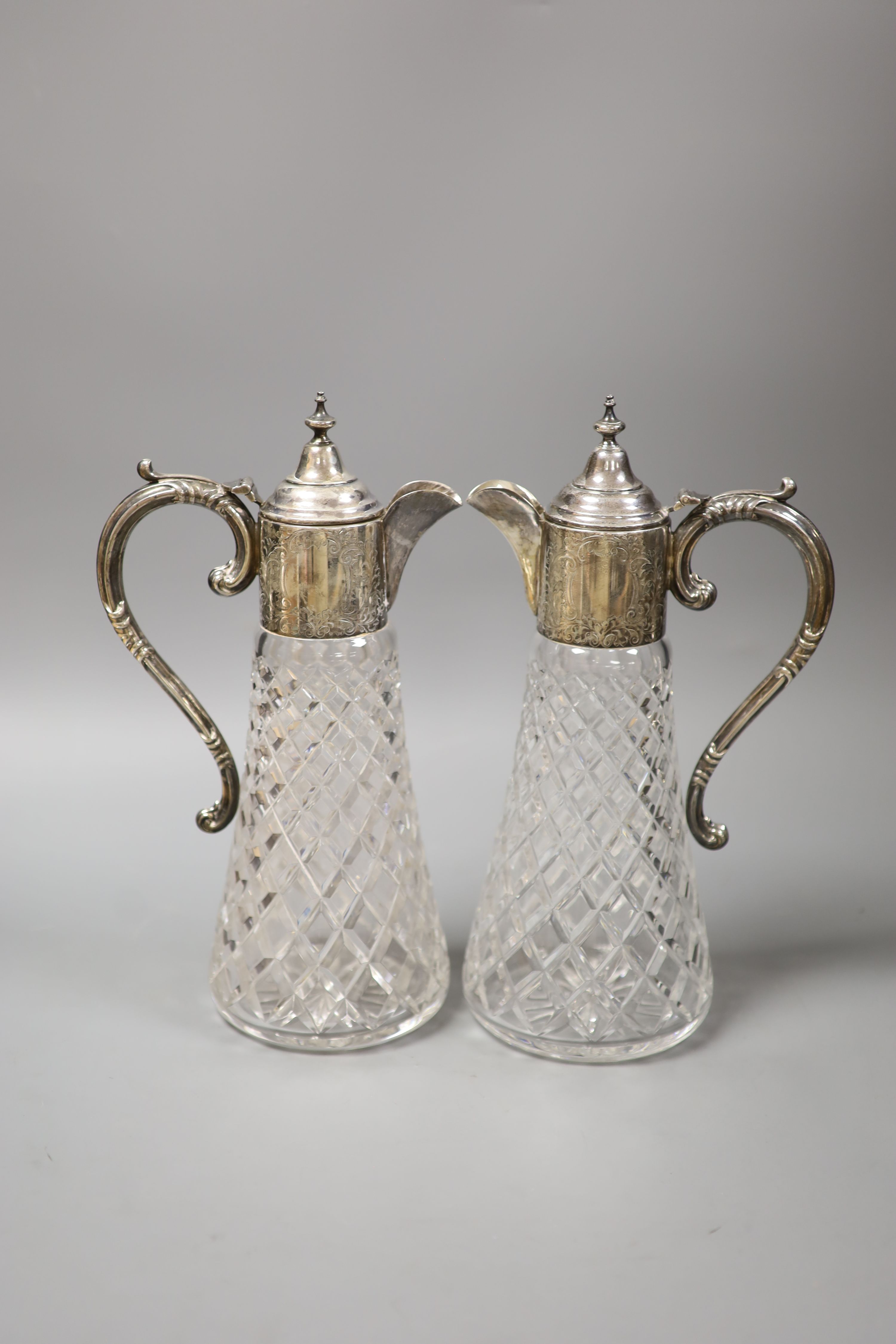 A pair of modern silver mounted cut glass claret jugs, Birmingham, 1972/74, height 32.3cm.